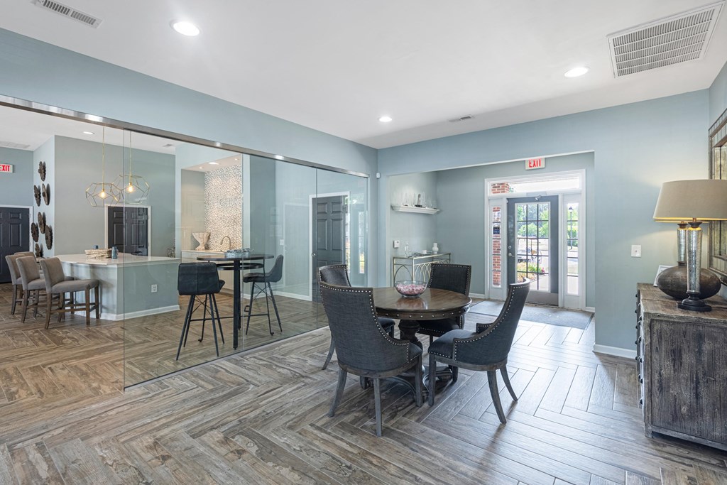 a large room with tables and chairs and a glass wall