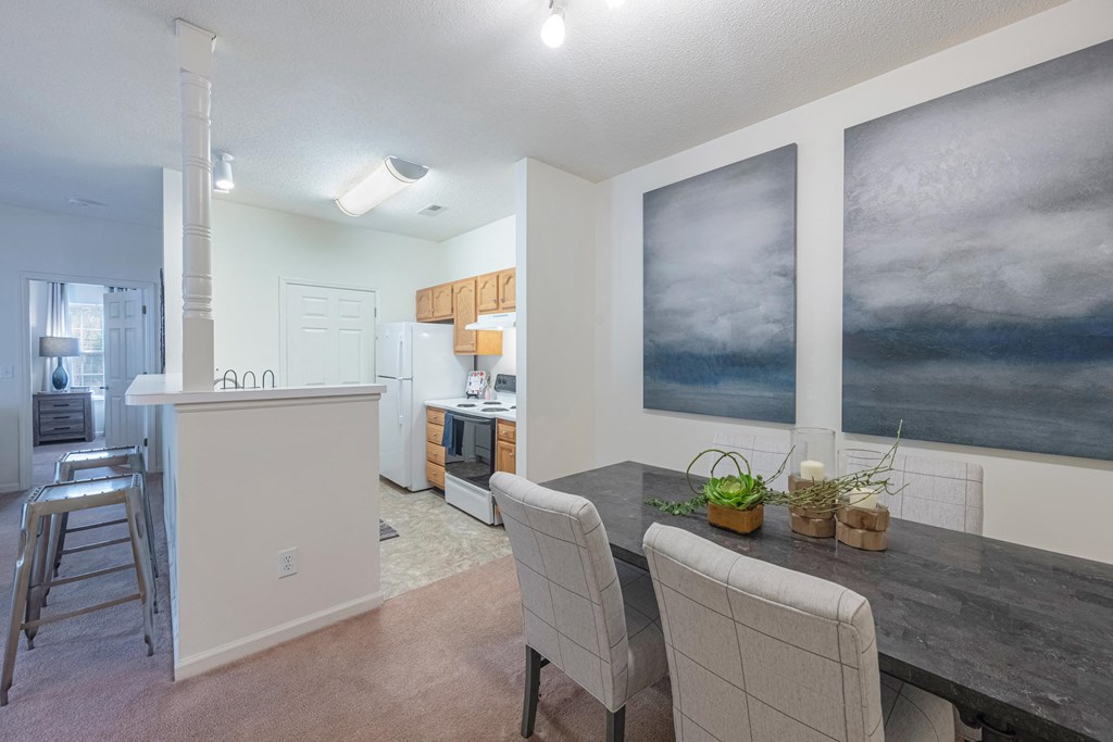 a kitchen and dining room with a table and chairs