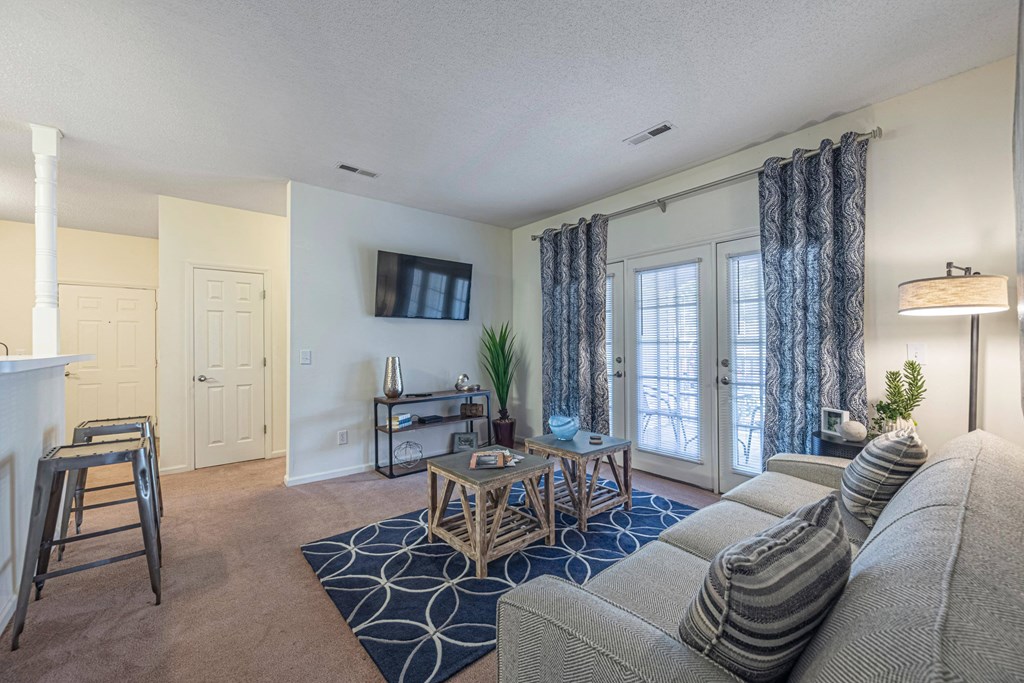 a living room with a couch and a coffee table and a tv