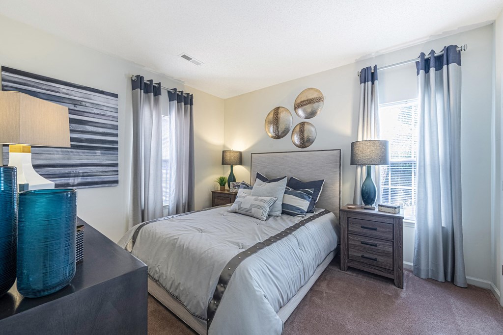 a bedroom with a large bed and a window