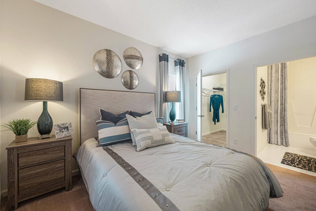 our apartments offer a bedroom with a large bed and a walk in closet
