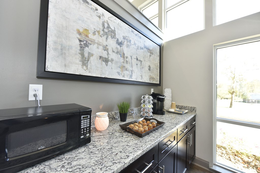 a kitchen with a microwave oven and a counter top with a tray of food on it