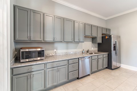 a kitchen with stainless steel appliances and gray cabinets
