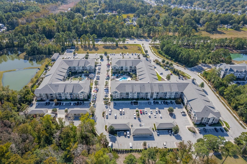 an aerial view of a resort with buildings and a pool