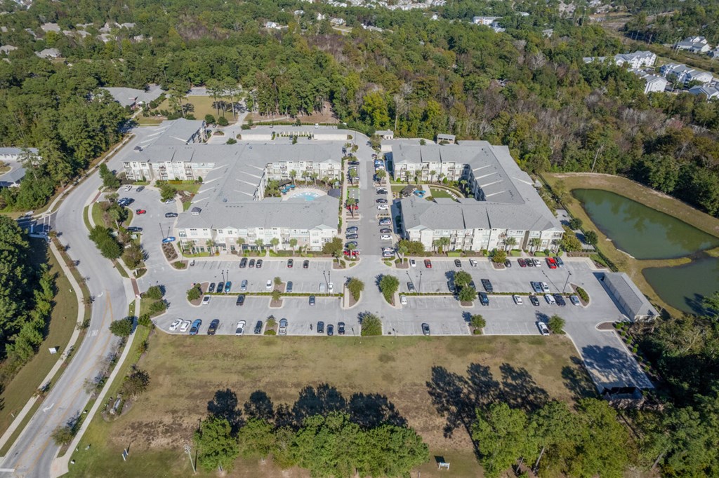 an aerial view of a parking lot and several buildings