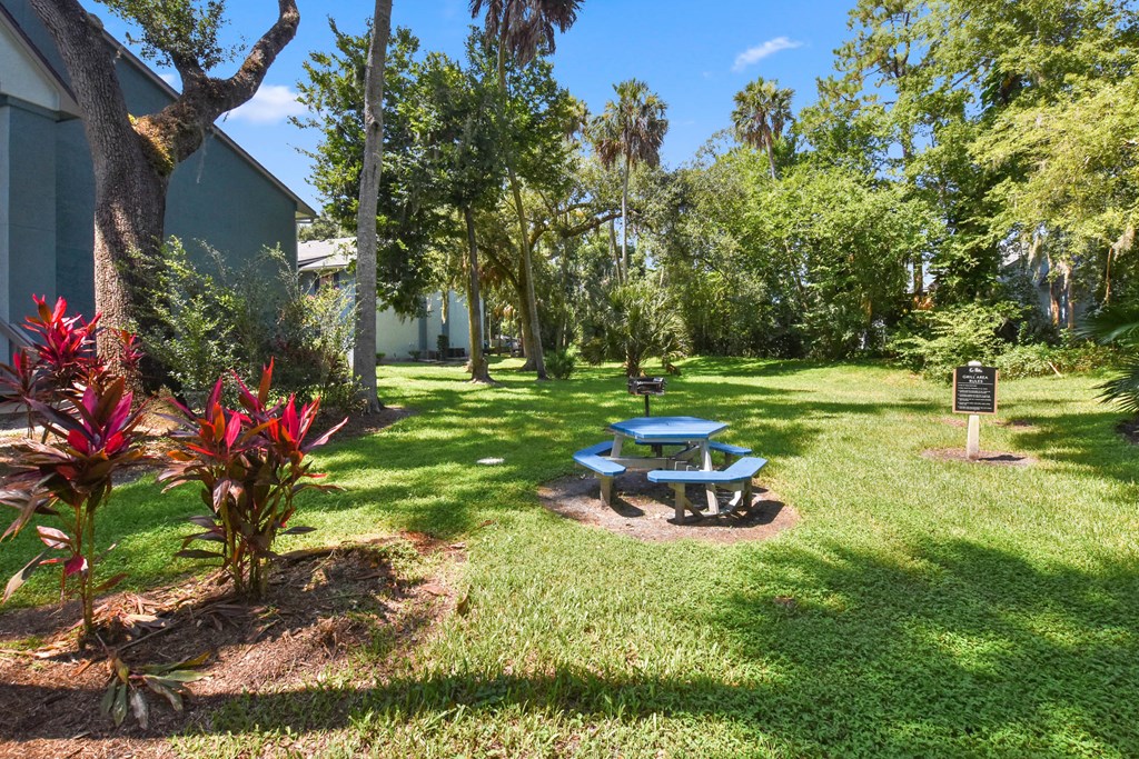 a picnic table sitting in the grass in a park