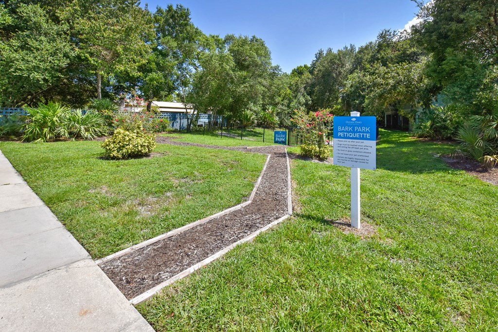 a park with a sign in the grass