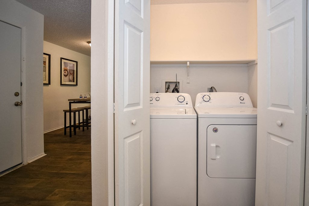 a washer and dryer in a laundry room with a dining room in the