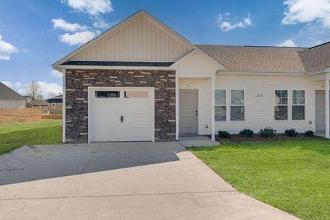 A two-story house with a garage on the first floor at Allen Ridge Townhomes in Greenville, NC.