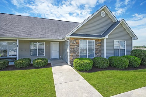 A house with a grey roof and a white door.