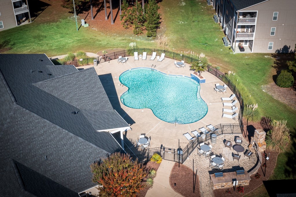 A small pool surrounded by a patio and deck.