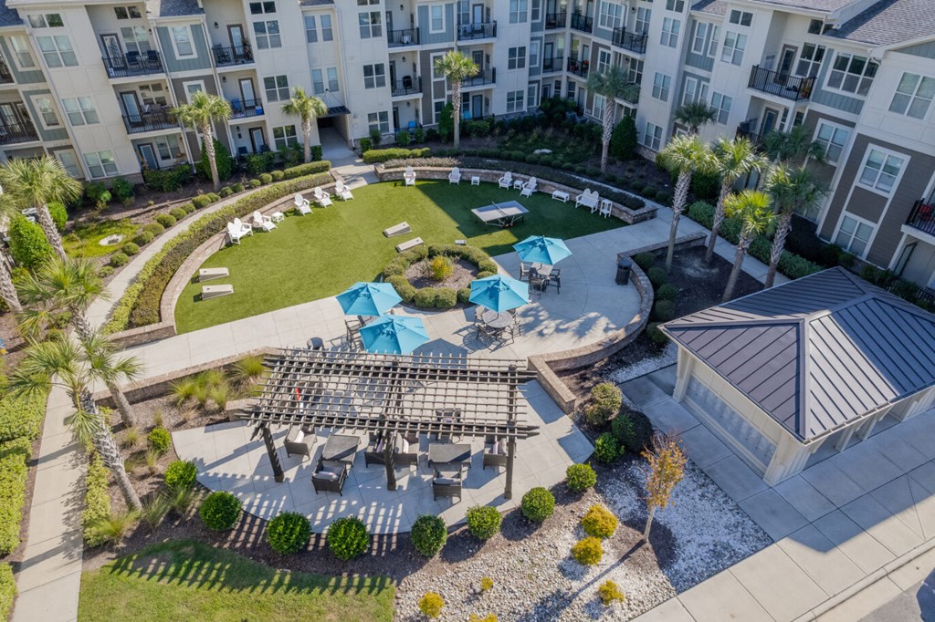 an aerial view of the courtyard of an apartment building with tables and chairs