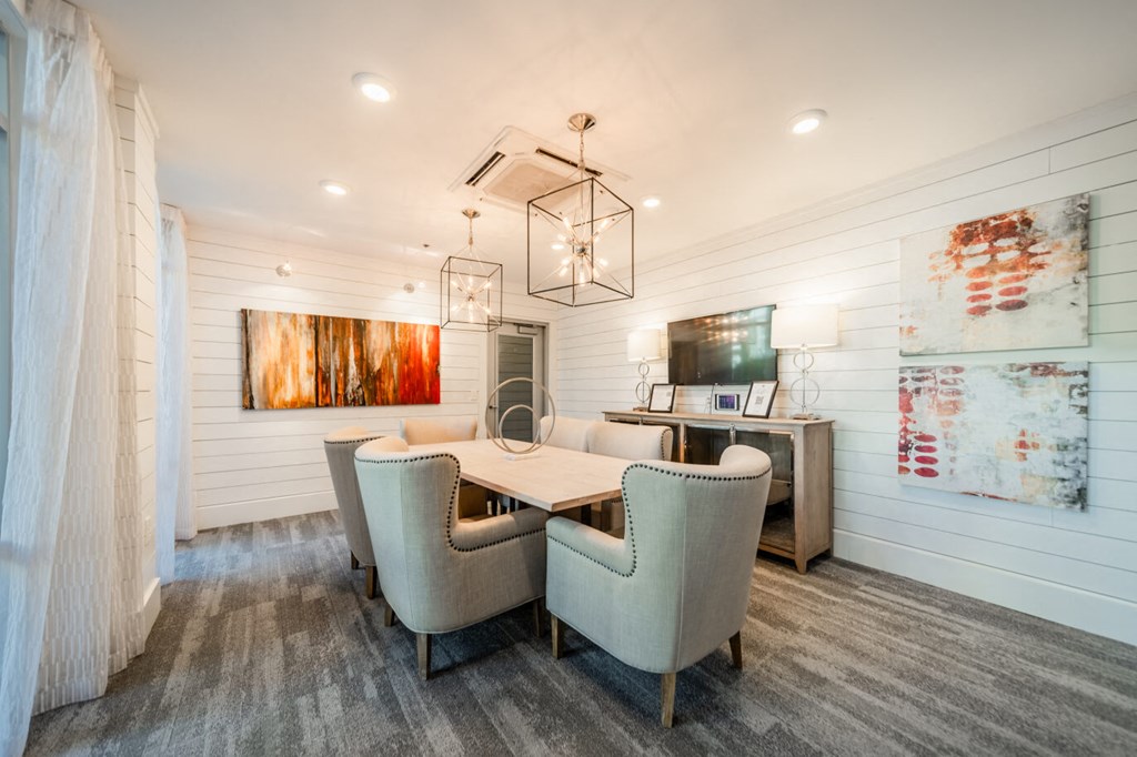a dining room with a table and chairs