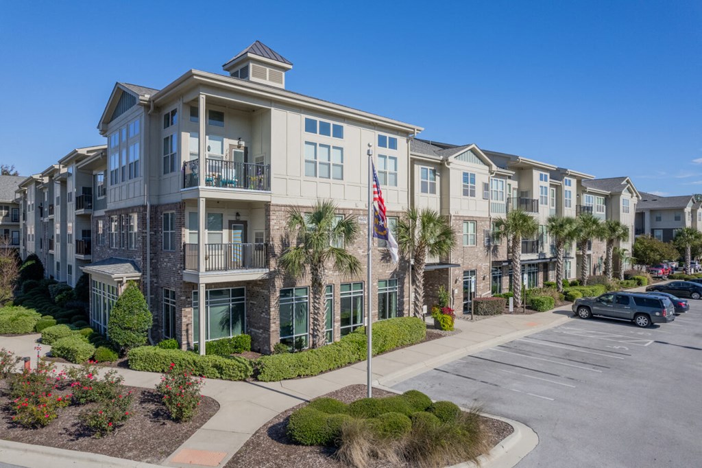 a building with palm trees and a flag in front of it
