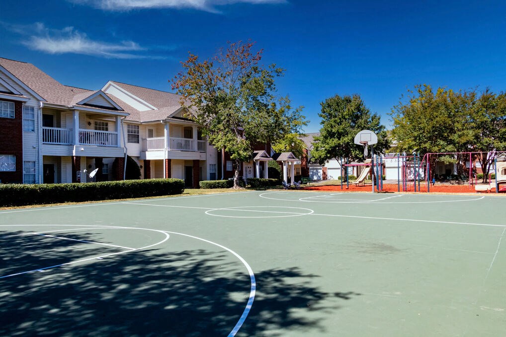 a basketball court in the middle of an apartment complex