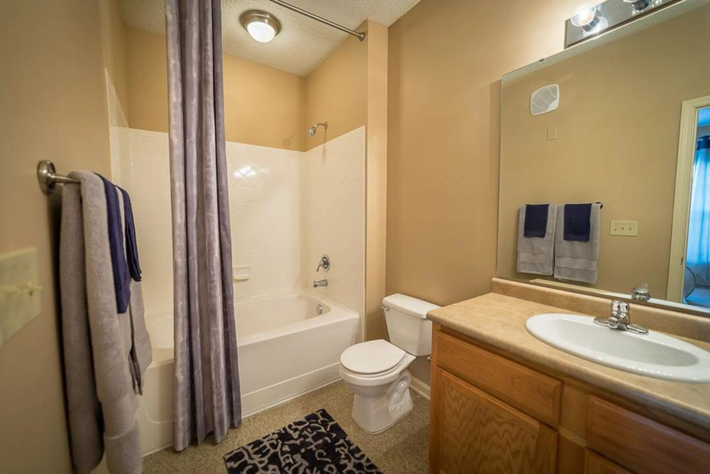 a bathroom with a sink toilet and a bath tub