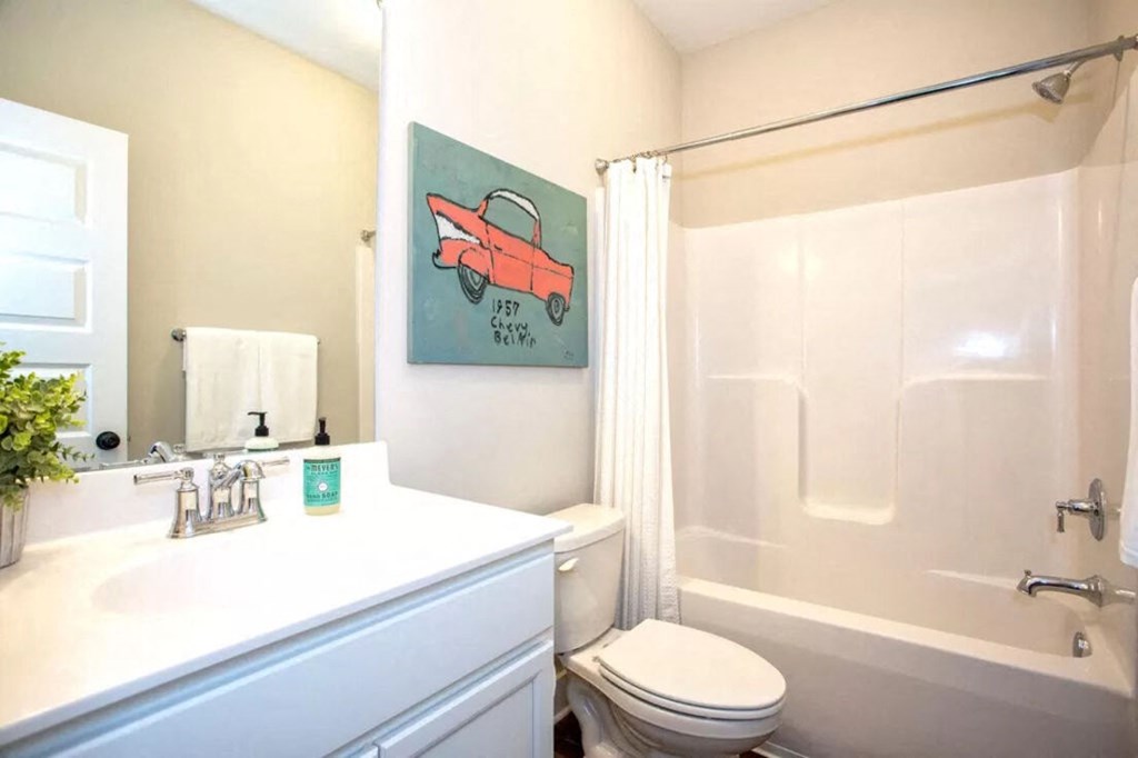 a bathroom with a shower and a toilet and a sink