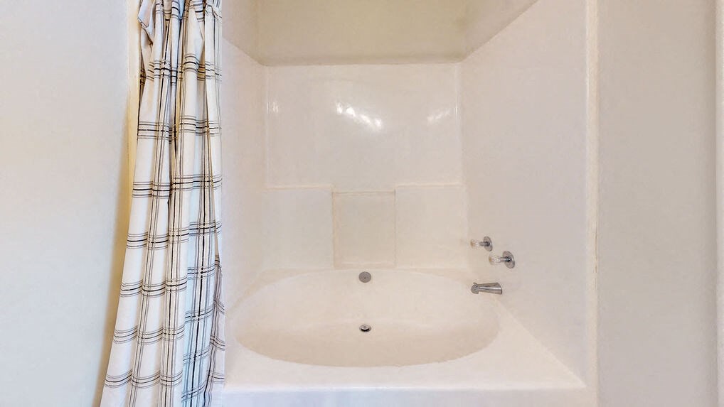 a bathroom with a sink and a shower curtain