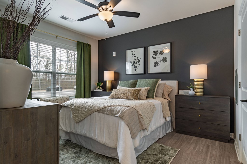 a bedroom with a bed and a ceiling fan