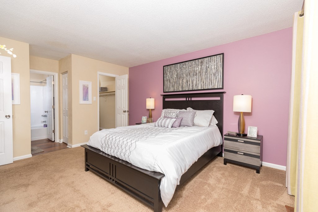 a bedroom with a large bed and purple walls