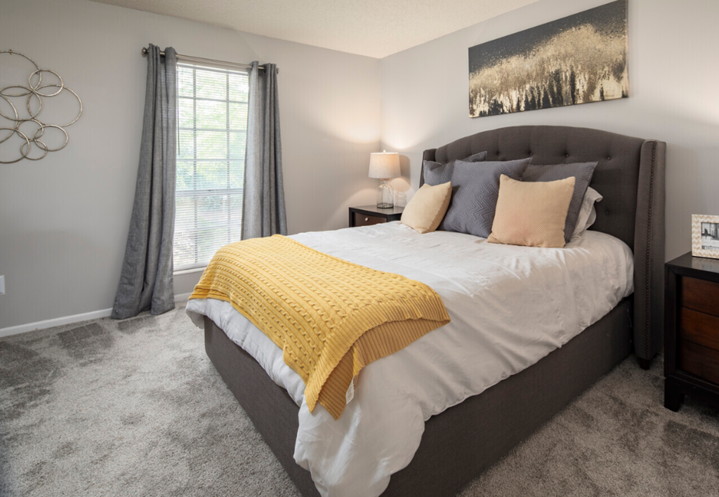 a bedroom with a large bed and a window