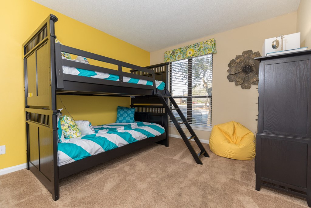 a bunk bed room with bunk beds and a window