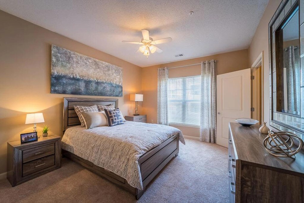 a bedroom with a bed and a ceiling fan