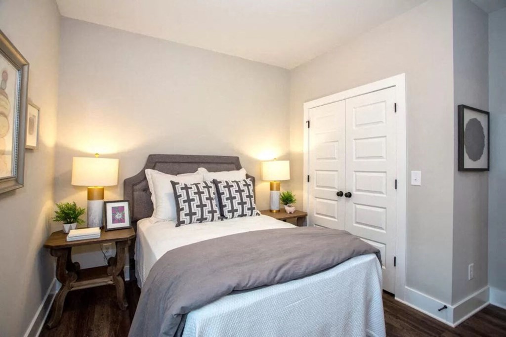 a bedroom with a bed and a white door