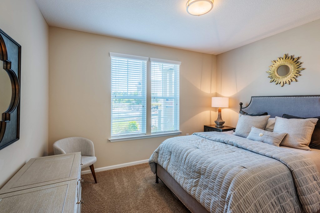 a bedroom with a bed and a desk with a chair