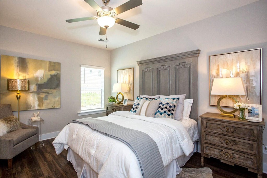 a bedroom with a bed and a ceiling fan