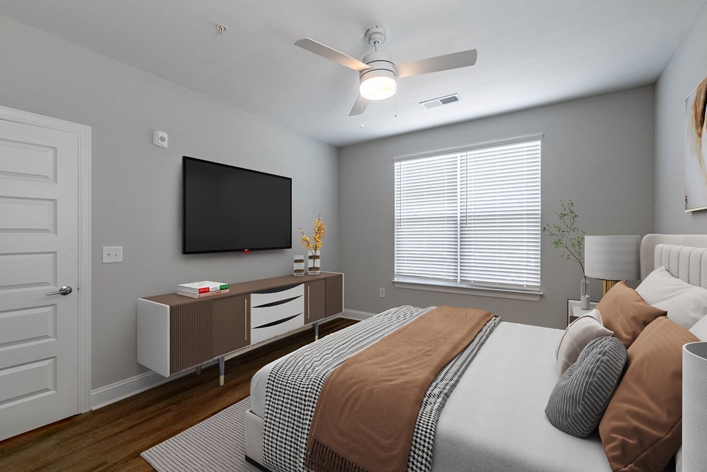 a bedroom with a large bed and a tv