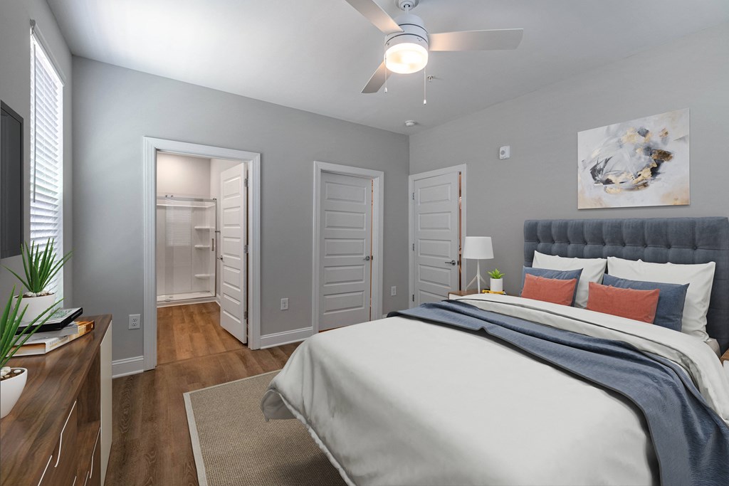 a bedroom with a large bed and a ceiling fan