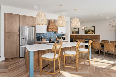 A kitchen with a table and chairs.