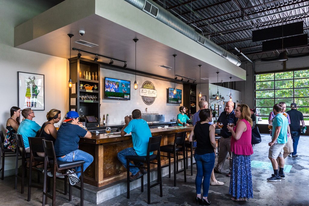A group of people are gathered in a bar.