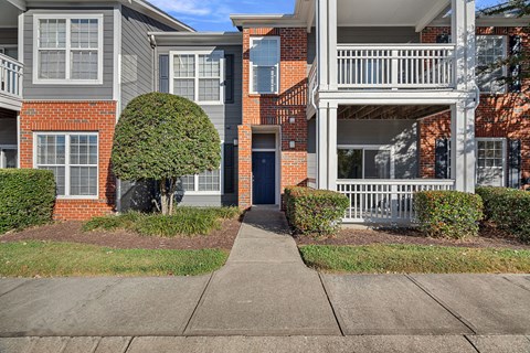 A building with a red brick facade and a grey trim.