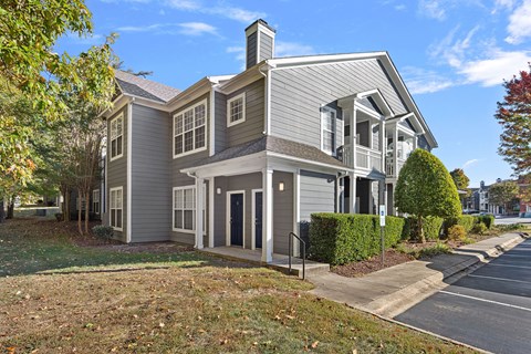 A grey house with a black door and windows.
