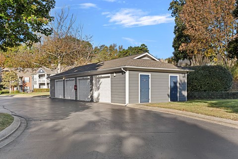 A two-car garage with a grey roof and blue doors.