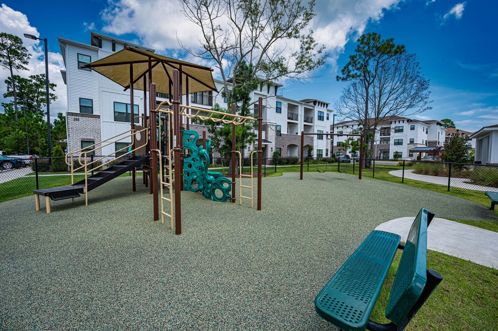 A playground with a slide, swings and a climbing frame.