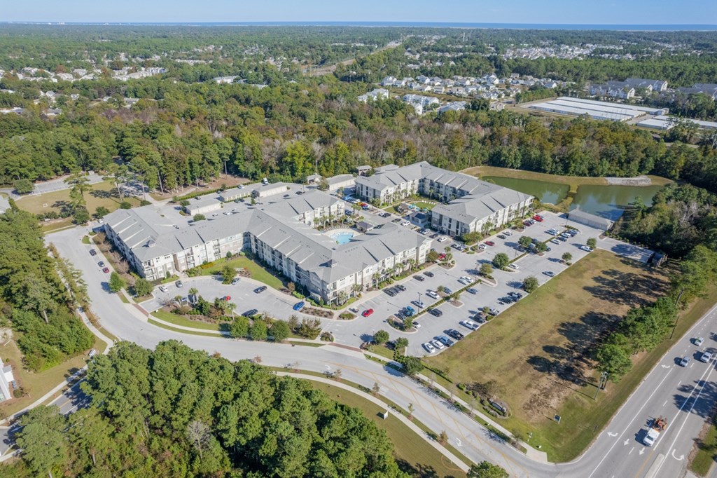 an aerial view of the apartments and parking lot