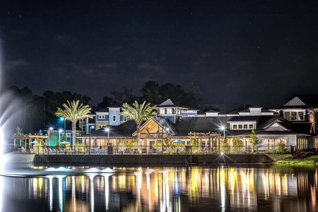 a city at night with lights on the water