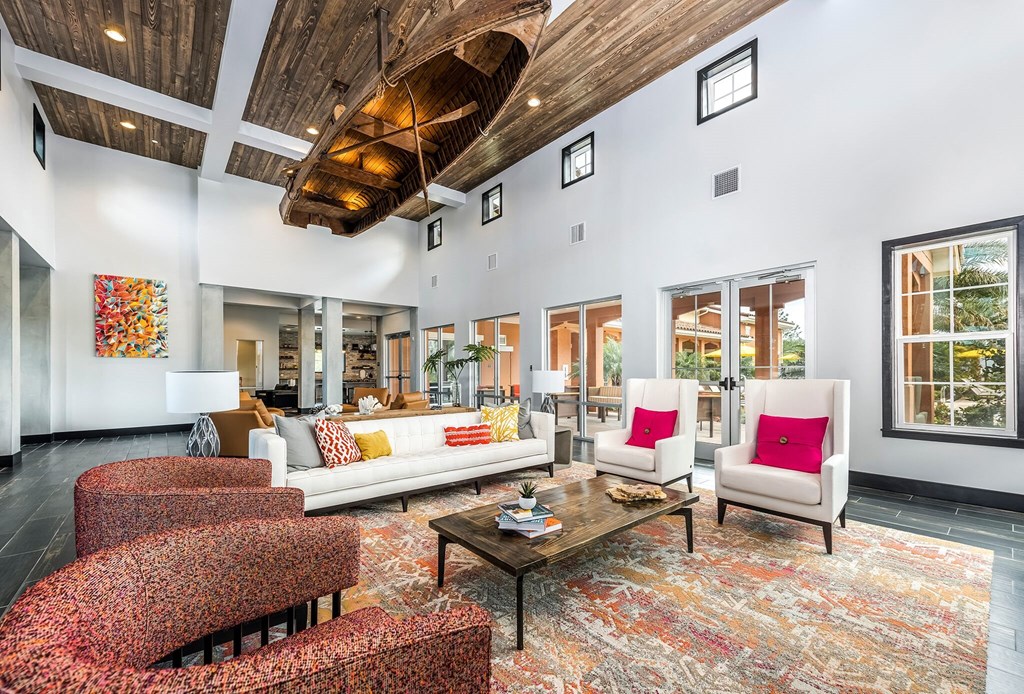 a living room with couches and chairs and a table