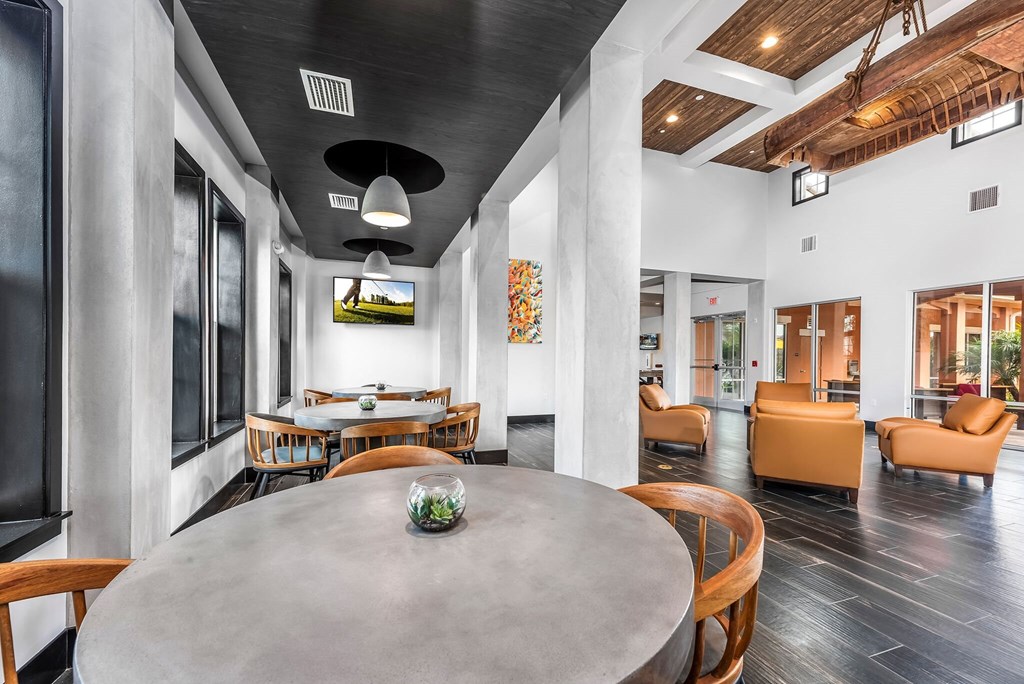 a living room with a round table and chairs