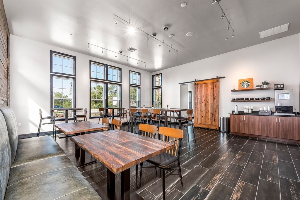 a dining room with wooden tables and chairs and windows
