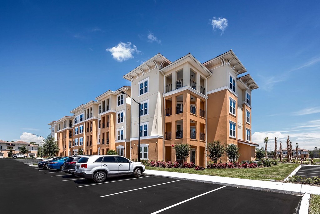 a parking lot in front of an apartment building