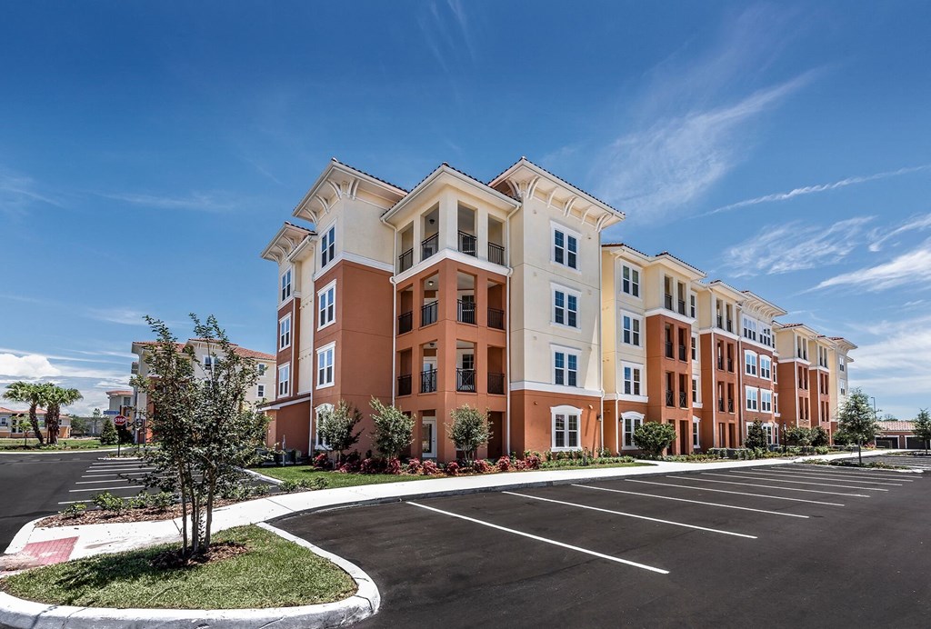 a street view of an apartment building on a sunny day
