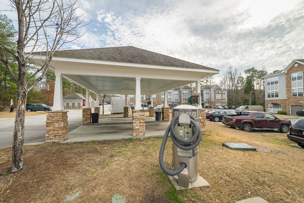 a parking meter sitting in front of a parking lot