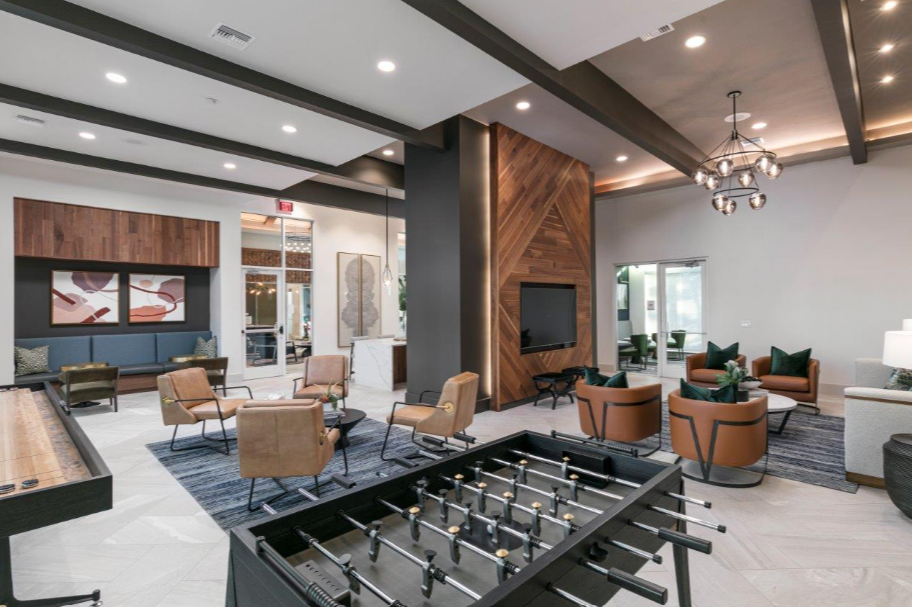 a game room with a foosball table and chairs