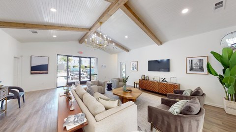 A living room with a white couch and a brown armchair.