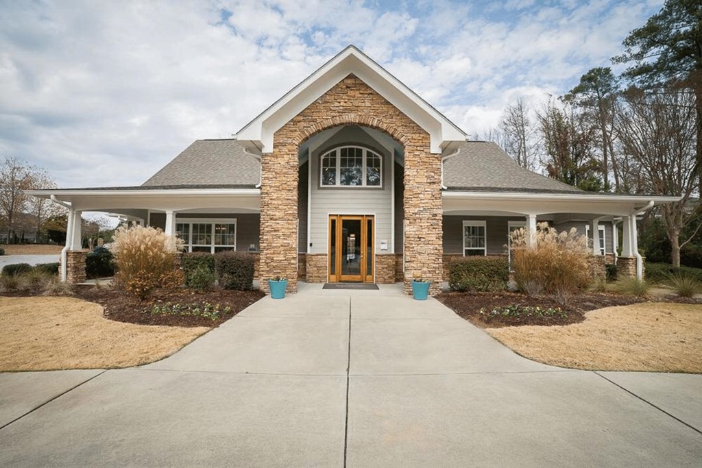 the front of a house with a walkway and a front door