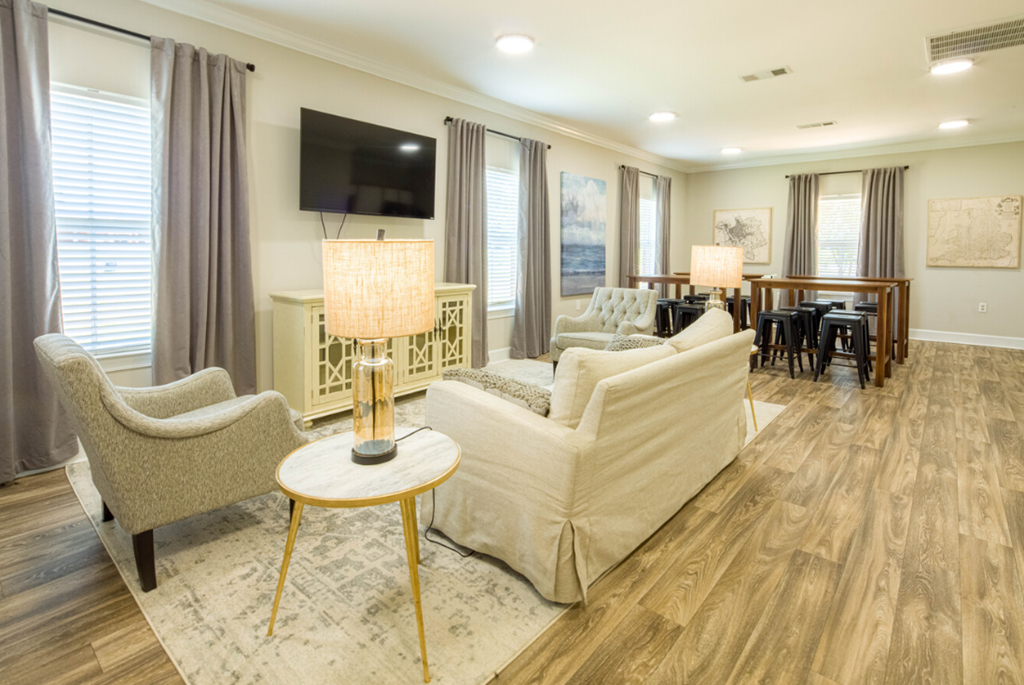 a living room with a couch and chairs and a table